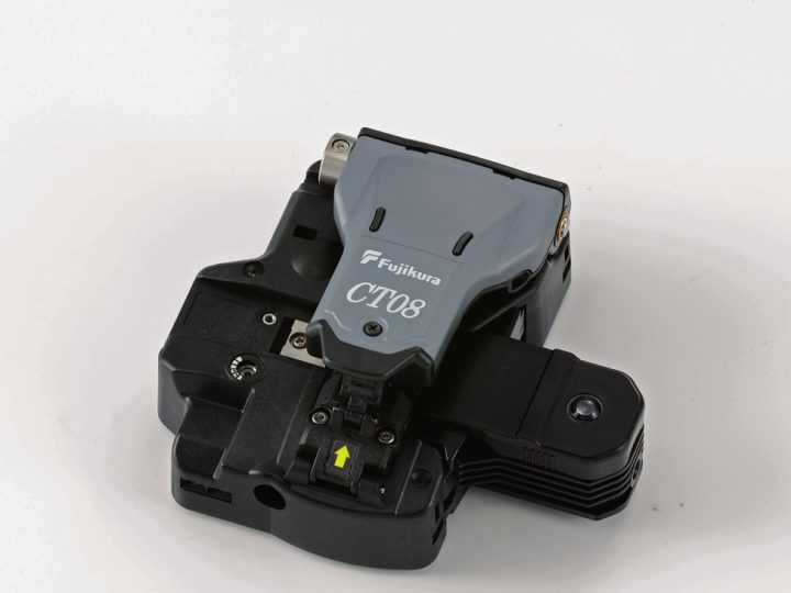 Three-quarter studio photo of a black Fujikura single-fibre cleaver with a grey top cover silk-screened with the Fujikura logo and the model name 'CT08'; blade thumbwheel, fibre clamp and yellow alignment arrow all visible.